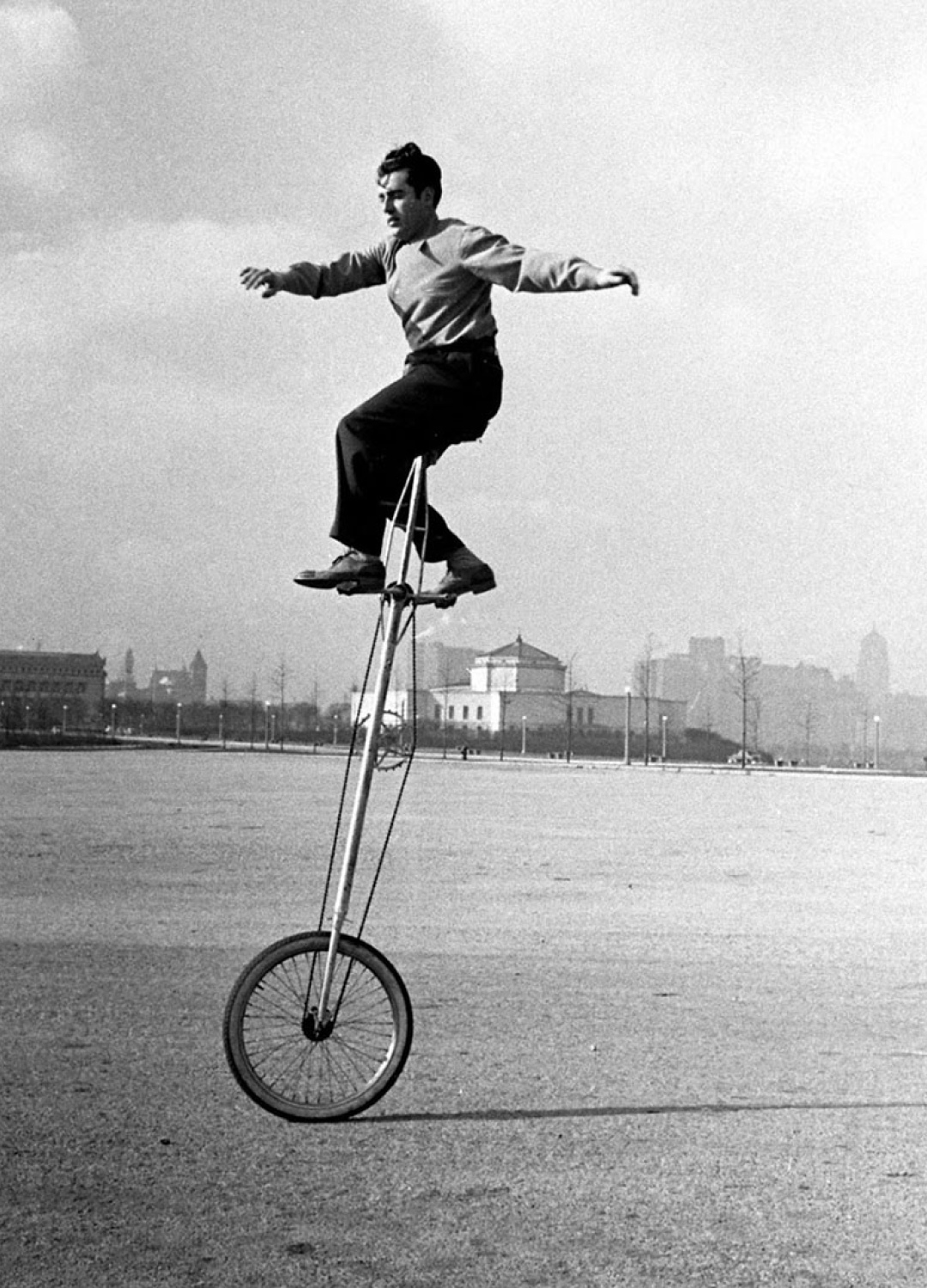 Historical photo man driving unicycle